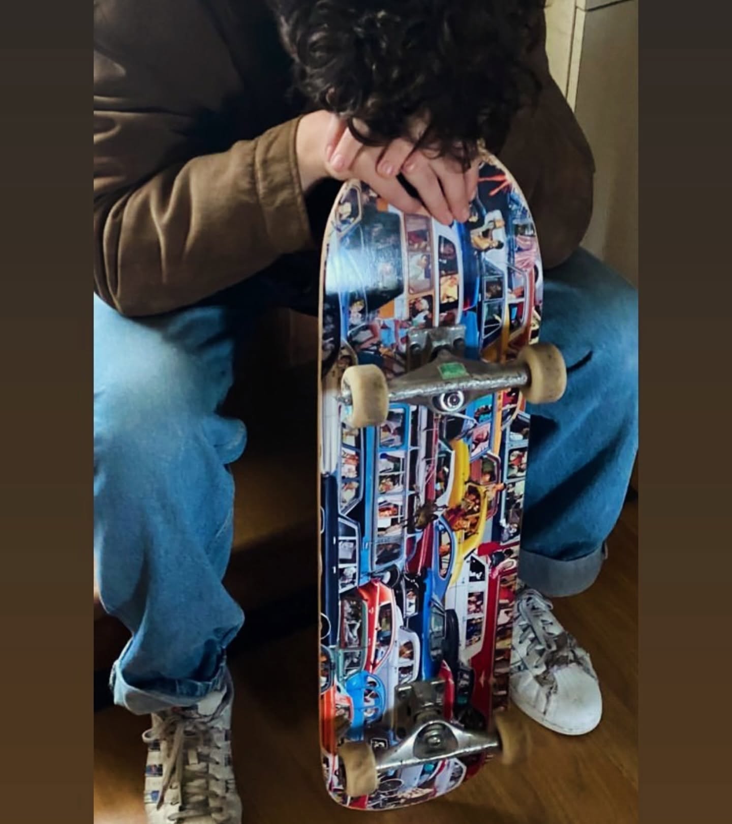 A skater holding the Traffic complete skateboard